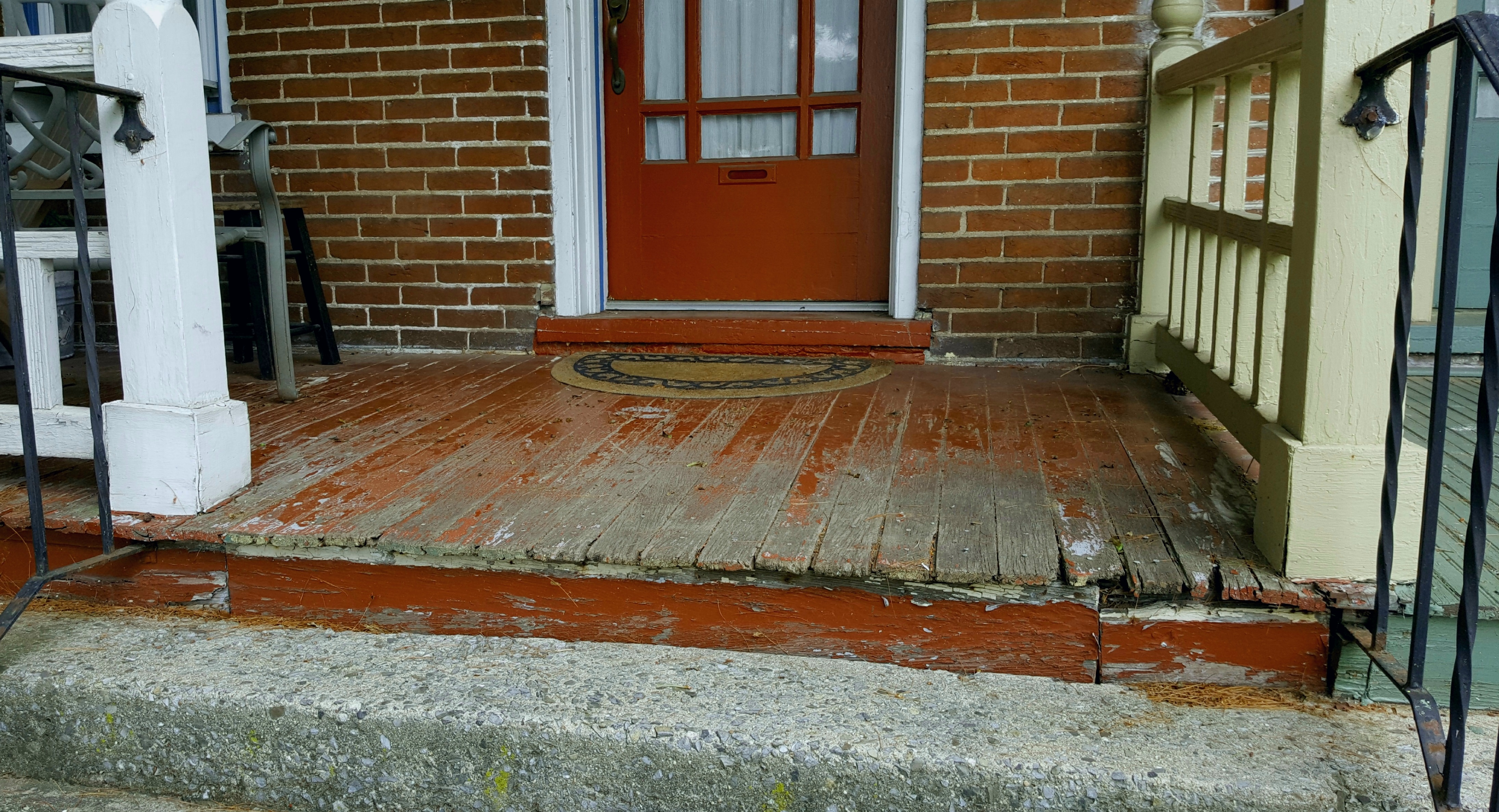 This front porch would regain its charm with a few new boards and a fresh coat of paint.